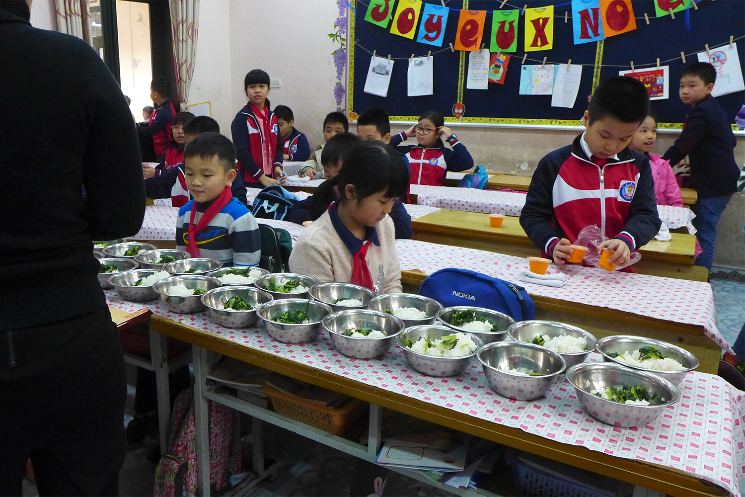 A midi, les enfants mangent dans la salle de cours.